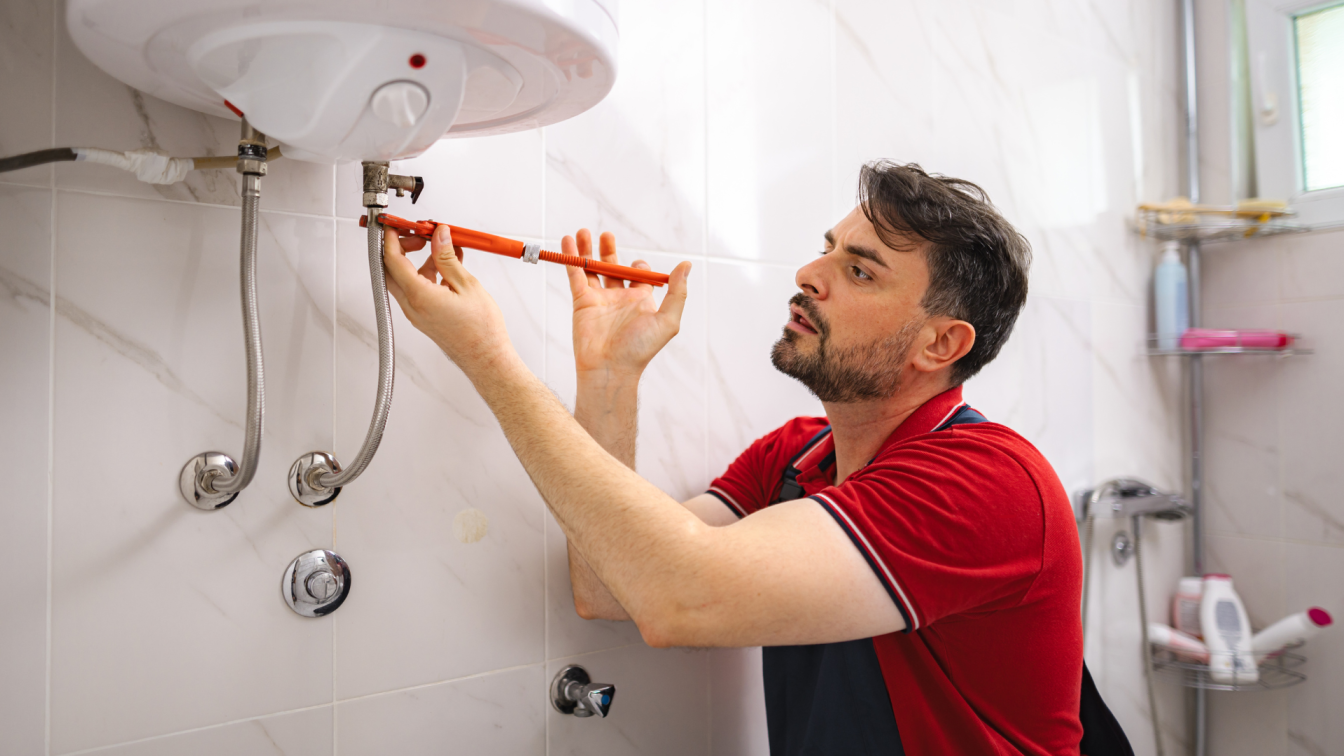 Licensed plumber installing a residential hot water heater